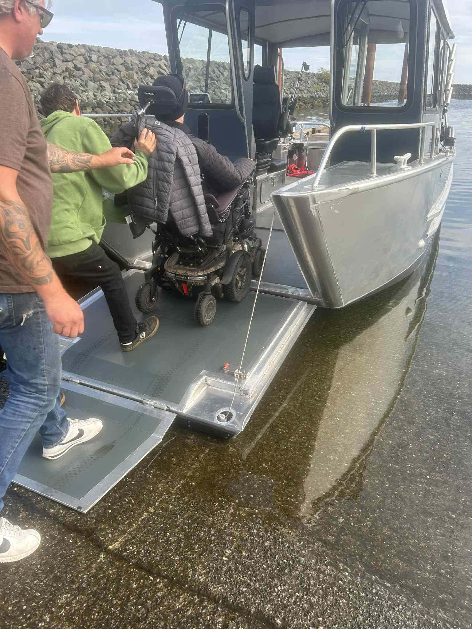 Wheelchair user boarding the boat via accessible ramp